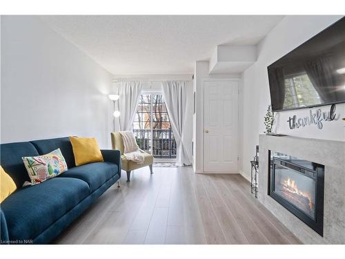 203-4090 John Charles Boulevard, Vineland, ON - Indoor Photo Showing Living Room With Fireplace