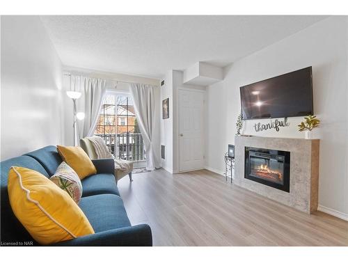 203-4090 John Charles Boulevard, Vineland, ON - Indoor Photo Showing Living Room With Fireplace