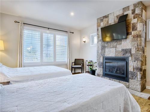 6039 Symmes Street, Niagara Falls, ON - Indoor Photo Showing Bedroom With Fireplace