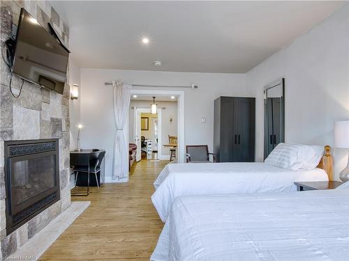 6039 Symmes Street, Niagara Falls, ON - Indoor Photo Showing Bedroom With Fireplace