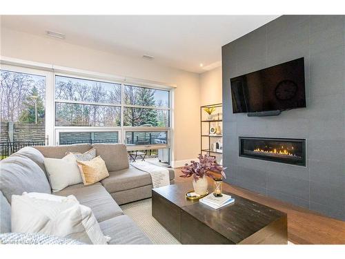 100-1705 Fiddlehead Place, London, ON - Indoor Photo Showing Living Room With Fireplace