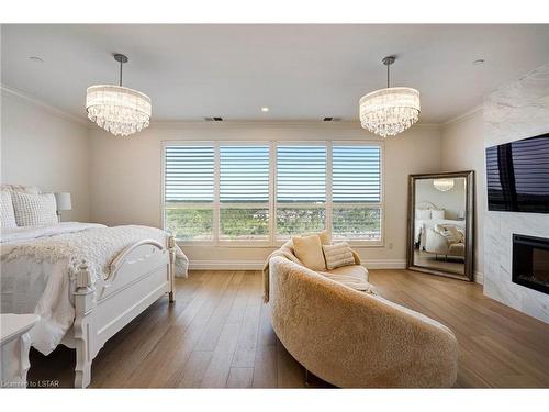 1103-260 Villagewalk Boulevard, London, ON - Indoor Photo Showing Bedroom With Fireplace