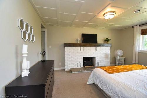 268 Highway 24 East, St. Williams, ON - Indoor Photo Showing Bedroom With Fireplace