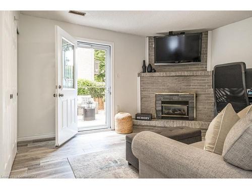 22-1155 Paramount Drive, Stoney Creek, ON - Indoor Photo Showing Living Room With Fireplace