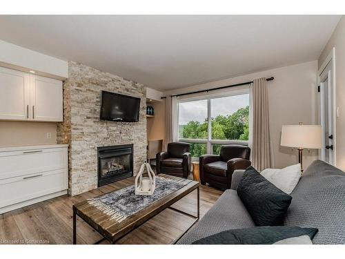 54-304-1235 Deerhurst Drive, Huntsville, ON - Indoor Photo Showing Living Room With Fireplace