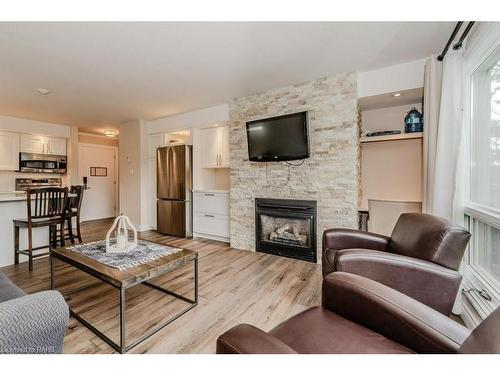 54-304-1235 Deerhurst Drive, Huntsville, ON - Indoor Photo Showing Living Room With Fireplace