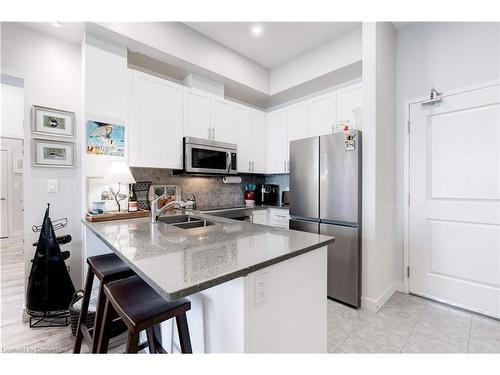 404-35 Southshore Crescent, Stoney Creek, ON - Indoor Photo Showing Kitchen With Stainless Steel Kitchen With Double Sink