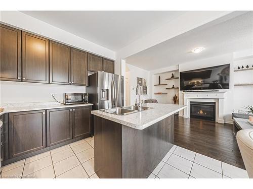 11 Mcwatters Street, Binbrook, ON - Indoor Photo Showing Kitchen With Fireplace With Double Sink