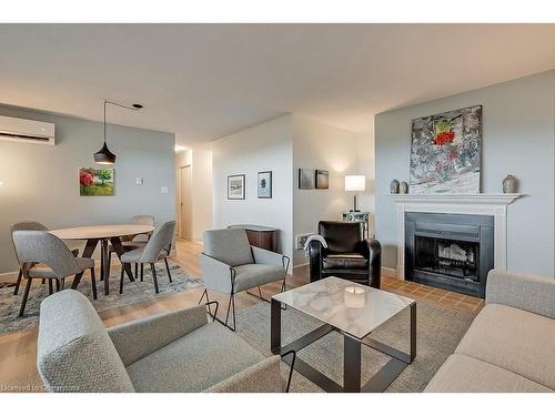 1003-700 Dynes Road, Burlington, ON - Indoor Photo Showing Living Room With Fireplace