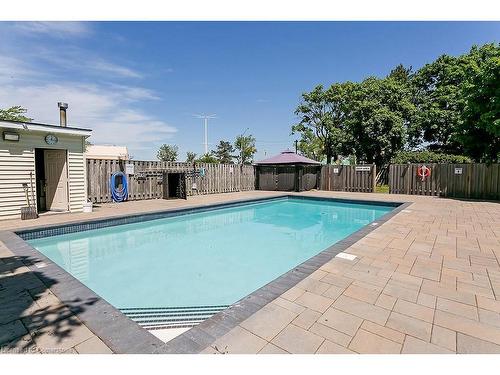 1003-700 Dynes Road, Burlington, ON - Outdoor With In Ground Pool With Backyard