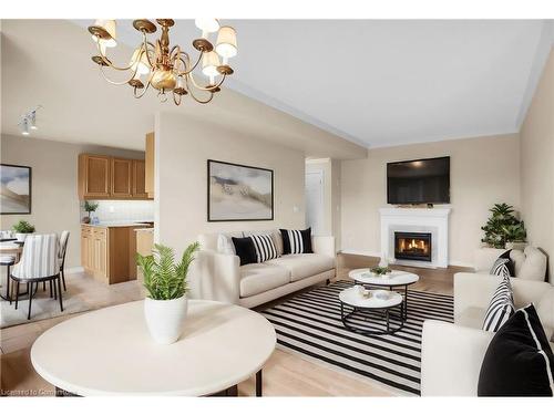 807-3000 Creekside Drive, Dundas, ON - Indoor Photo Showing Living Room With Fireplace