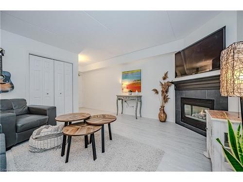 301-1441 Walker'S Line, Burlington, ON - Indoor Photo Showing Living Room With Fireplace