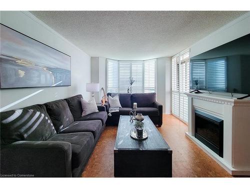 108-1225 North Shore Boulevard E, Burlington, ON - Indoor Photo Showing Living Room With Fireplace