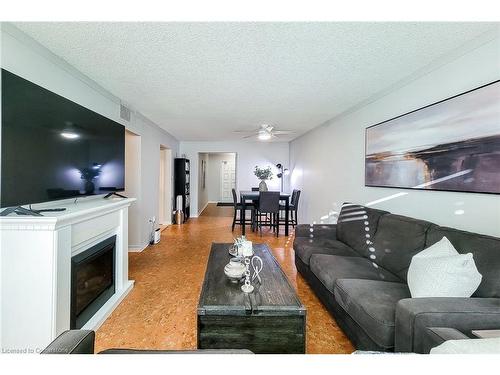 108-1225 North Shore Boulevard E, Burlington, ON - Indoor Photo Showing Living Room With Fireplace