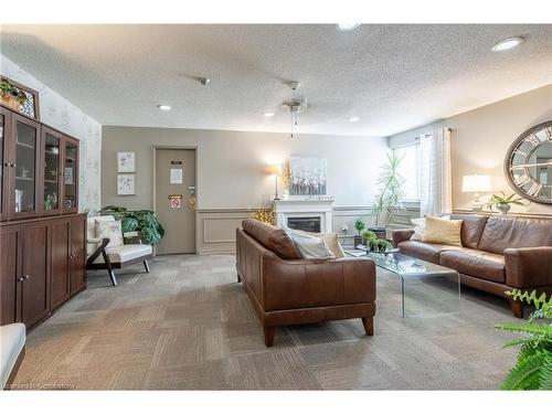 212-196 Scott Street, St. Catharines, ON - Indoor Photo Showing Living Room With Fireplace