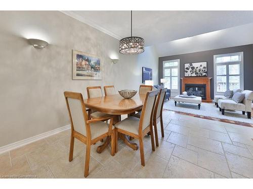 24-289 Plains Road W, Burlington, ON - Indoor Photo Showing Dining Room With Fireplace