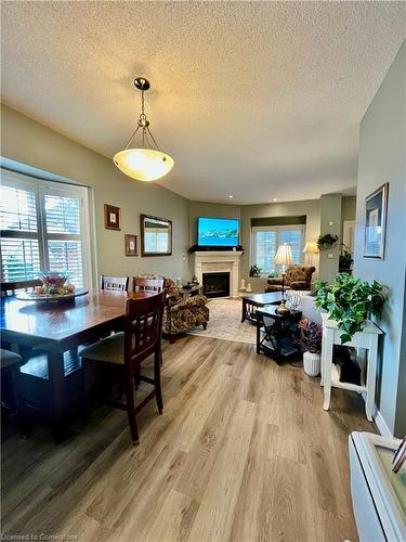 21-1375 Stephenson Drive, Burlington, ON - Indoor Photo Showing Dining Room With Fireplace