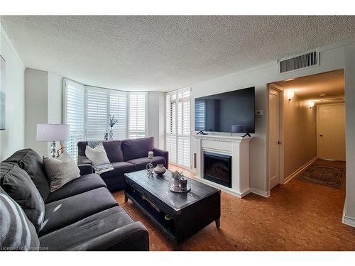 108-1225 North Shore Boulevard E, Burlington, ON - Indoor Photo Showing Living Room With Fireplace