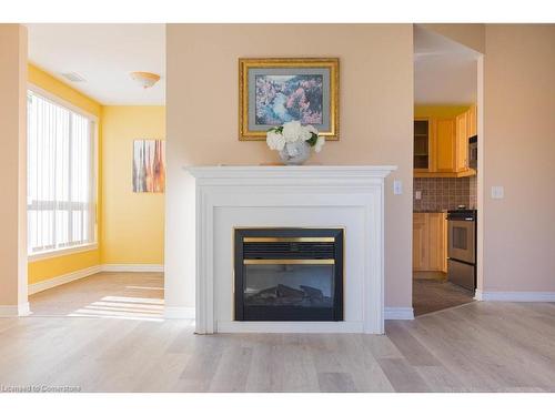 305-2000 Creekside Drive, Dundas, ON - Indoor Photo Showing Living Room With Fireplace