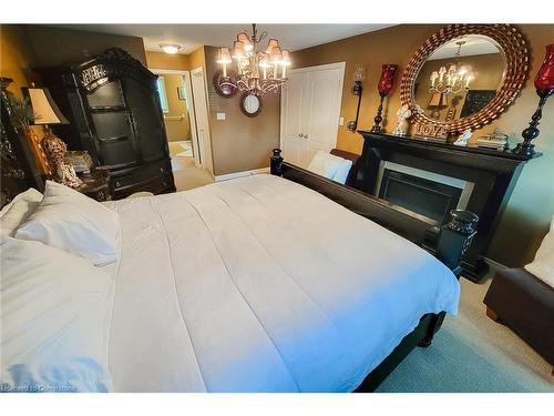 26 Grassyplain Drive, Mount Hope, ON - Indoor Photo Showing Bedroom With Fireplace