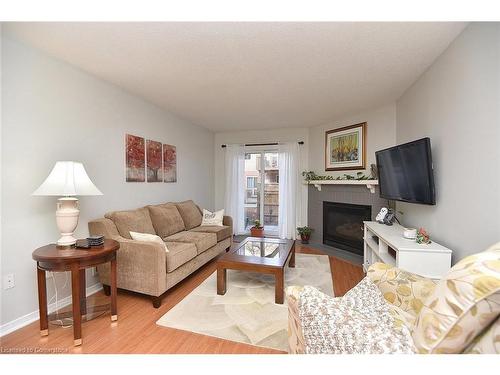 102-2055 Walkers Line, Burlington, ON - Indoor Photo Showing Living Room With Fireplace