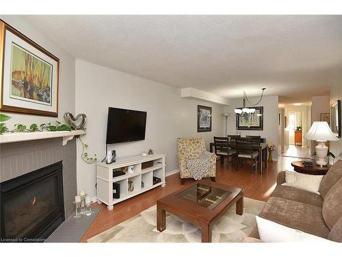 102-2055 Walkers Line, Burlington, ON - Indoor Photo Showing Living Room With Fireplace