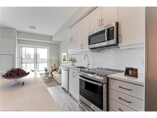 321-128 Grovewood Common, Oakville, ON - Indoor Photo Showing Kitchen With Stainless Steel Kitchen With Upgraded Kitchen