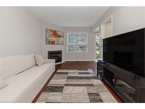 112-2555 Thomas Street, Mississauga, ON - Indoor Photo Showing Living Room With Fireplace