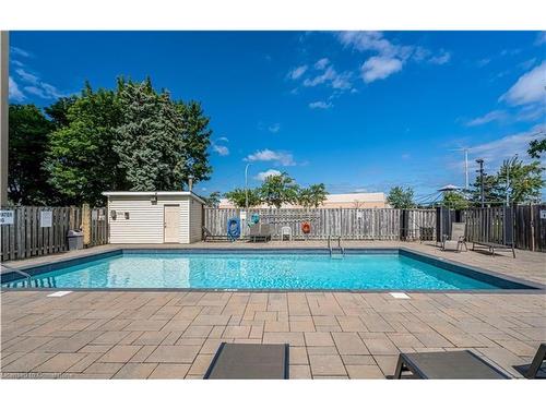 406-700 Dynes Road, Burlington, ON - Outdoor With In Ground Pool With Backyard