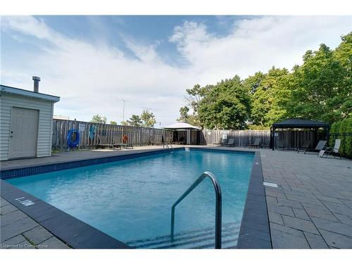 109-700 Dynes Road, Burlington, ON - Outdoor With In Ground Pool With Backyard