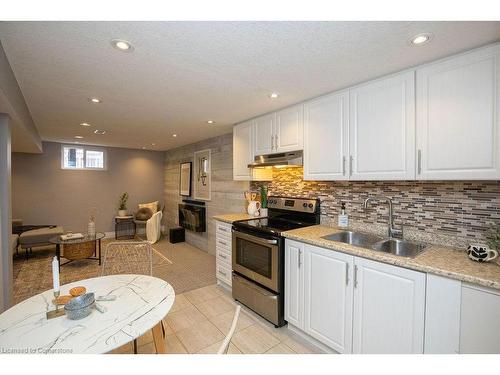 Lower-551 Barnaby Street, Hamilton, ON - Indoor Photo Showing Kitchen With Fireplace With Double Sink