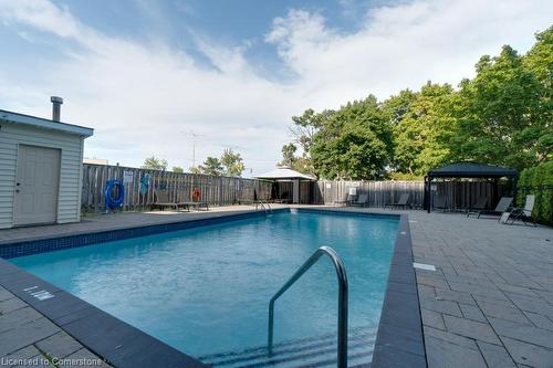 705-700 Dynes Road, Burlington, ON - Outdoor With In Ground Pool With Backyard