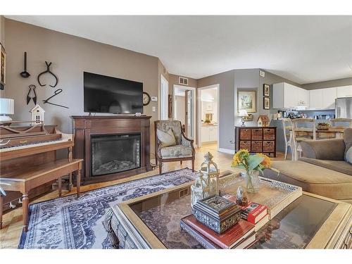 213-2030 Cleaver Avenue, Burlington, ON - Indoor Photo Showing Living Room With Fireplace