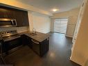 103-128 Grovewood Common, Oakville, ON  - Indoor Photo Showing Kitchen With Double Sink 