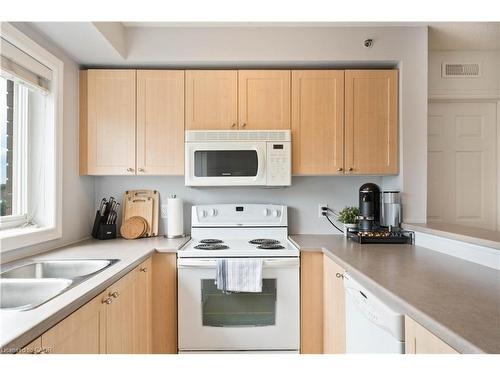 304-4450 Fairview Street, Burlington, ON - Indoor Photo Showing Kitchen With Double Sink