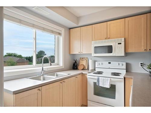 304-4450 Fairview Street, Burlington, ON - Indoor Photo Showing Kitchen With Double Sink