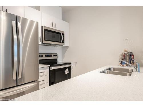 512-1936 Rymal Road E, Hamilton, ON - Indoor Photo Showing Kitchen With Stainless Steel Kitchen With Double Sink