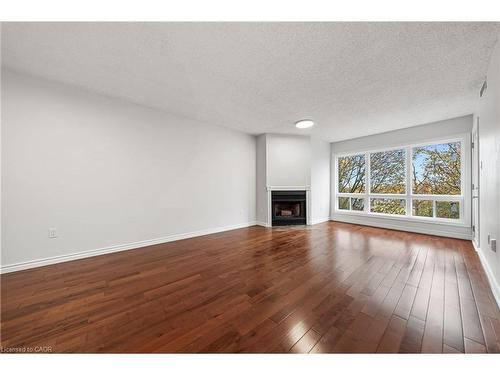 406-15 Hofstetter Avenue, Kitchener, ON - Indoor Photo Showing Living Room With Fireplace