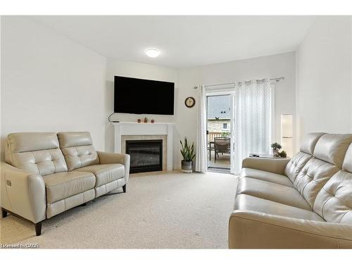 20-310 Southbrook Drive, Binbrook, ON - Indoor Photo Showing Living Room With Fireplace