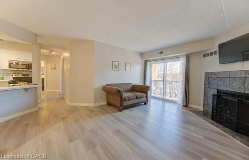 27-3085 Kingsway Drive, Kitchener, ON - Indoor Photo Showing Living Room With Fireplace