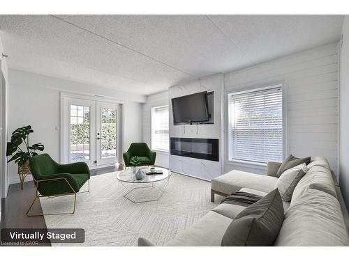 113-2035 Appleby Line, Burlington, ON - Indoor Photo Showing Living Room With Fireplace
