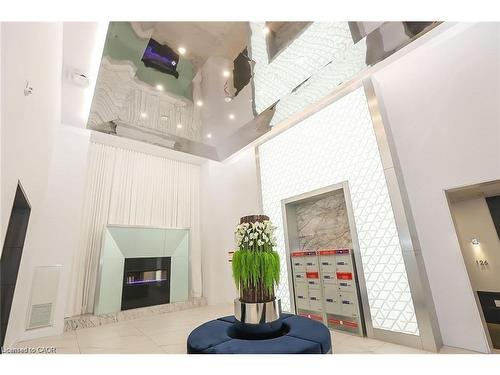 530-16 Concord Place, Grimsby, ON - Indoor Photo Showing Other Room With Fireplace