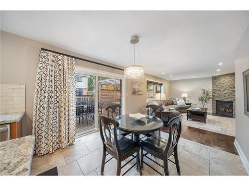 1351 Mcguffin Gate, Milton, ON - Indoor Photo Showing Dining Room With Fireplace