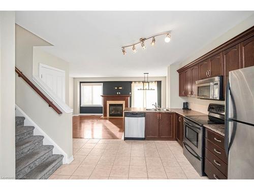 23-222 Fall Fair Way, Binbrook, ON - Indoor Photo Showing Kitchen With Fireplace With Double Sink
