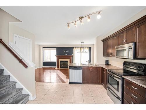 23-222 Fall Fair Way, Binbrook, ON - Indoor Photo Showing Kitchen With Fireplace With Double Sink