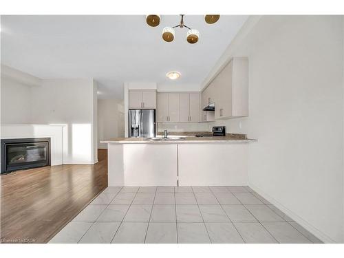 76 Prest Way, Centre Wellington, ON - Indoor Photo Showing Kitchen With Fireplace