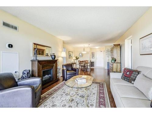 706-1201 North Shore Boulevard E, Burlington, ON - Indoor Photo Showing Living Room With Fireplace