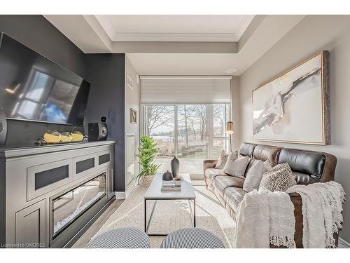 129-3500 Lakeshore Road W, Oakville, ON - Indoor Photo Showing Living Room With Fireplace
