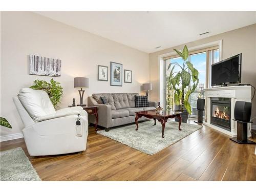 212-383 Main Street E, Milton, ON - Indoor Photo Showing Living Room With Fireplace