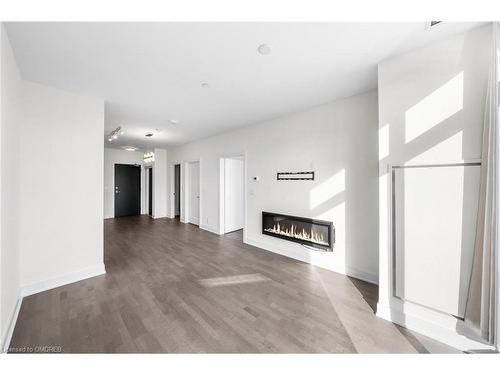 404-1575 Lakeshore Road W, Mississauga, ON - Indoor Photo Showing Other Room With Fireplace